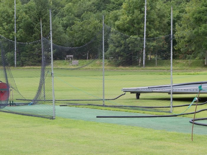 Cricket practice nets and roller on a maintained sports ground